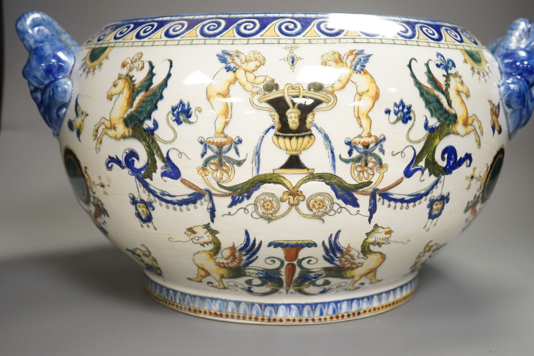 A French 19th century Gien pottery jardiniere with dolphin handles, 41 cms wide including handles.